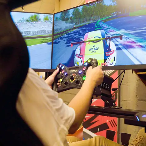 The Sim Rig has a cockpit setup, GT racing seat, triple-screen monitor and F1 steering wheel.