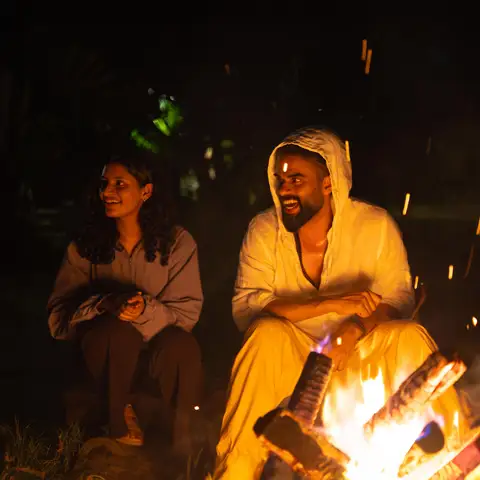 Gather around an inviting bonfire at night.